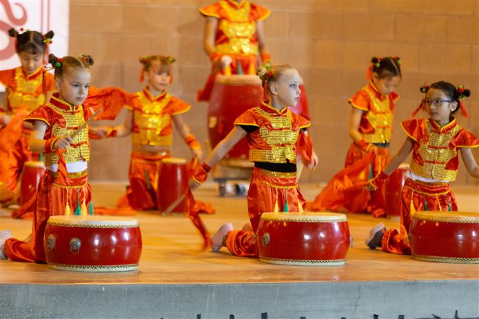  An image of students performing with drums in Tarwater's Dual Language Immersion Mandarin program.